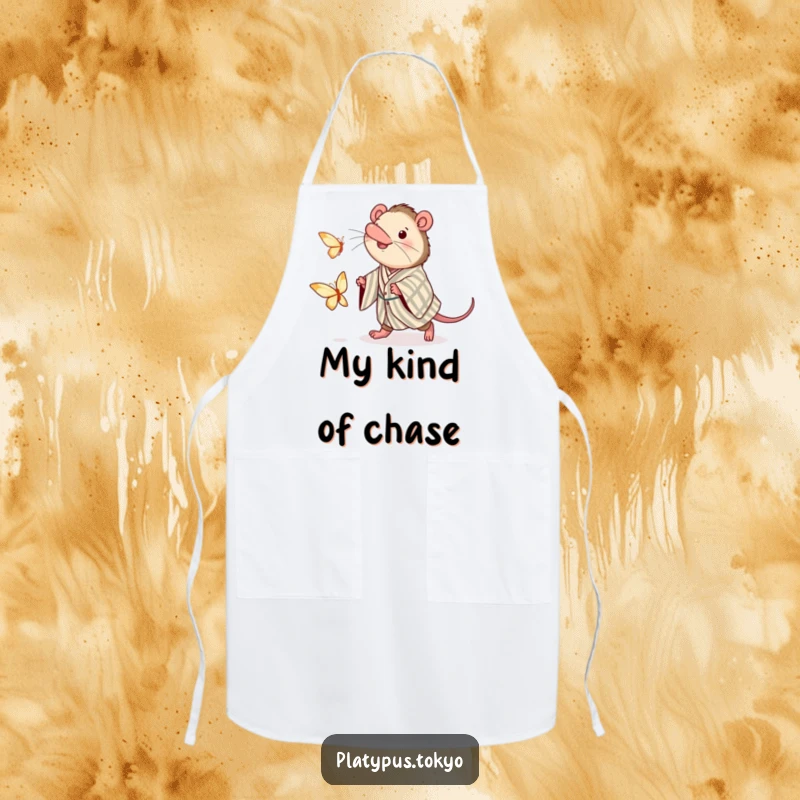 Funny apron designed with a platypus in a kimono, eagerly chasing a paper butterfly, ready for culinary adventures.