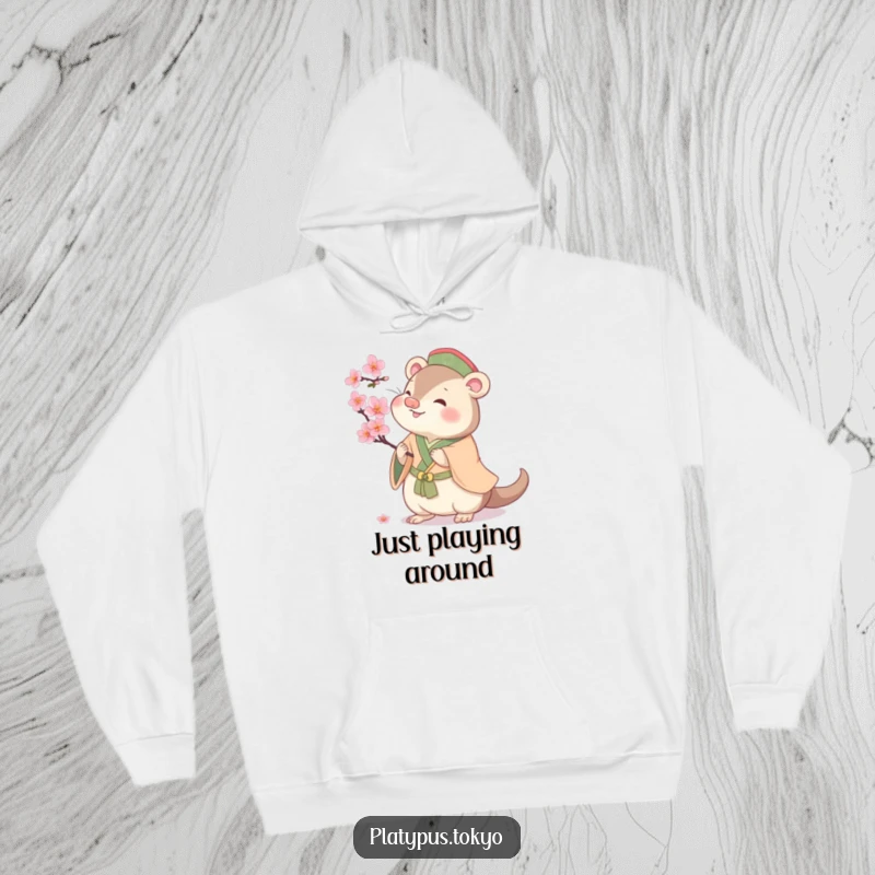 Funny cherubic platypus batting at a cherry blossom, on a warm hoodie, for cozy and cheerful spring vibes.