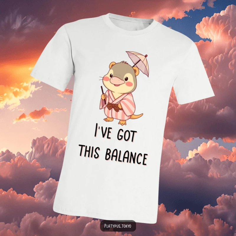 Funny platypus t-shirt in a pastel kimono, humorously balancing a small umbrella on its beak, showcasing playful charm.