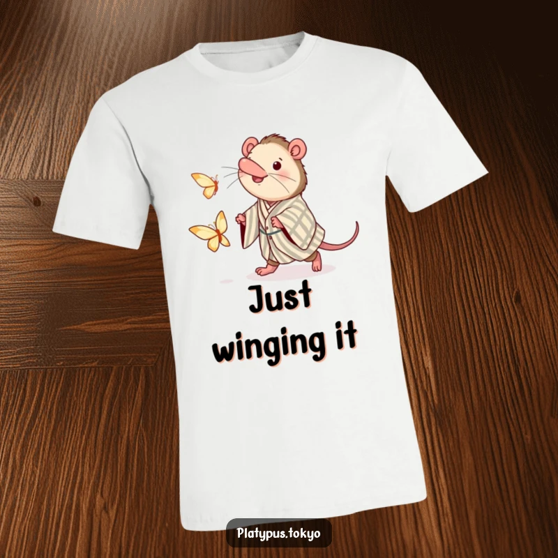 Funny t-shirt depicting an energetic platypus in a traditional kimono, enthusiastically pursuing a floating paper butterfly.